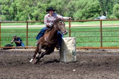 A rider on horseback rounding a barrel at speed in a dirt arena, representing the barrel racing event cancelled at the 2026 Royal Manitoba Winter Fair. Photo: Alexis Stockford.
