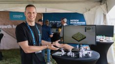 Andrew Lessey of Antler Bio standing at a booth with the EpiHerd platform displayed on a monitor behind him, at an ag-tech accelerator event in Canada. Photo: Courtesy Andrew Lessey