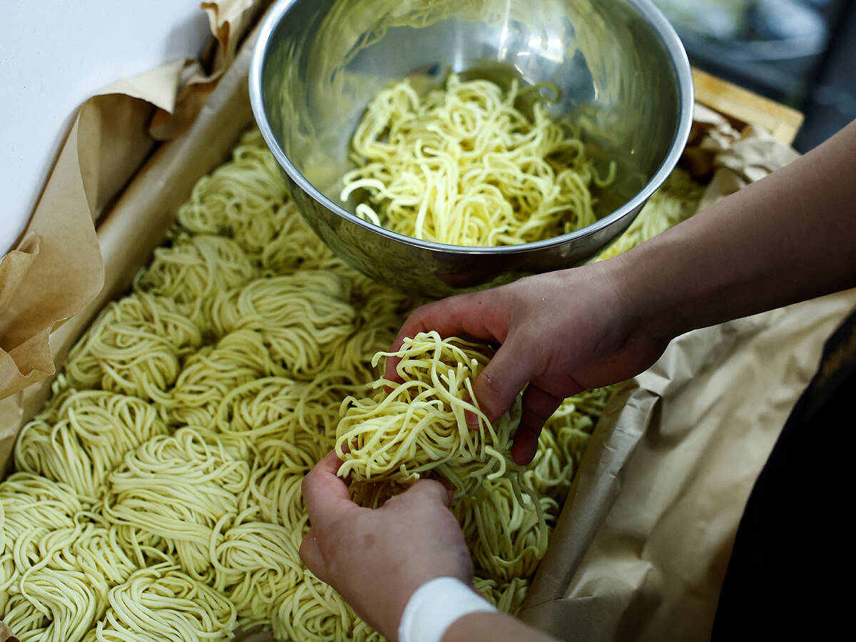 Ramen shop Menya Taisei's owner Taisei Hikage prepares to cook ramen with noodles at his shop in Tokyo, Japan, October 22, 2024. REUTERS/Kim Kyung-Hoon