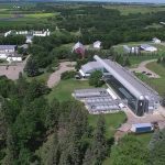 Aerial view of the Agriculture and Agri-Food Canada Brandon Research Centre, showing research buildings, greenhouses and surrounding Prairie farmland in summer. Photo: AAFC.
